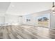 Bright, open basement living area with built-in shelving, a sliding glass door and luxury vinyl flooring at 15969 Sonnet Park Ln, Westfield, IN 46074