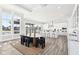 Dining area with modern table and chairs, large windows, and access to the kitchen at 15969 Sonnet Park Ln, Westfield, IN 46074