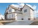 Three-car garage with an expansive driveway and manicured lawn at 15969 Sonnet Park Ln, Westfield, IN 46074