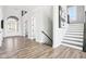 Welcoming foyer featuring hardwood floors, staircase, and ample natural light at 15969 Sonnet Park Ln, Westfield, IN 46074