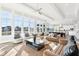 Open-concept living room with large windows, hardwood floors, and stylish furnishings at 15969 Sonnet Park Ln, Westfield, IN 46074