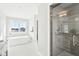 Bright main bathroom with soaking tub, glass shower, and modern fixtures at 15969 Sonnet Park Ln, Westfield, IN 46074