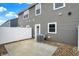 Back patio with white fence, gravel bed, gray vinyl siding, and air conditioning unit at 19487 Grassy Branch Rd, Westfield, IN 46074