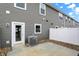 Back patio with white fence, gravel bed, gray vinyl siding, and air conditioning unit at 19487 Grassy Branch Rd, Westfield, IN 46074