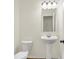 Modern half-bathroom featuring pedestal sink, toilet and wood-look flooring at 19487 Grassy Branch Rd, Westfield, IN 46074