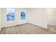 Bright, carpeted bedroom with natural light from two windows offers closet and neutral decor at 19487 Grassy Branch Rd, Westfield, IN 46074