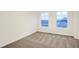 Bedroom with neutral walls and carpeting, featuring two windows for natural light at 19487 Grassy Branch Rd, Westfield, IN 46074