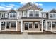 Inviting two-story townhome with stone accents, stylish siding, and covered porch at 19487 Grassy Branch Rd, Westfield, IN 46074