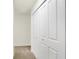Hallway view featuring bi-fold closet doors and neutral walls and carpet at 19487 Grassy Branch Rd, Westfield, IN 46074
