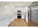 Contemporary kitchen with stainless steel appliances, white cabinets, and stylish countertops at 19487 Grassy Branch Rd, Westfield, IN 46074
