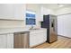 Well-lit kitchen with stainless steel appliances, white cabinets, and breakfast bar at 19487 Grassy Branch Rd, Westfield, IN 46074