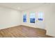 Light-filled living room features wood-look flooring and access to the staircase at 19487 Grassy Branch Rd, Westfield, IN 46074