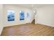Bright living room with wood-look flooring, natural light, and staircase access at 19487 Grassy Branch Rd, Westfield, IN 46074