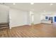 Open-concept living area with wood-style floors, stairs, and adjacent kitchen at 19487 Grassy Branch Rd, Westfield, IN 46074