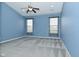 Tranquil bedroom with blue walls, two windows, and patterned carpet flooring at 2228 Silver Rose Dr, Avon, IN 46123