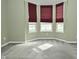 Cozy bedroom featuring three windows and gray carpet flooring at 2228 Silver Rose Dr, Avon, IN 46123