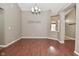 Open dining area with warm-toned walls, a decorative chandelier, and wood-look flooring at 2228 Silver Rose Dr, Avon, IN 46123