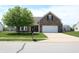 Charming brick home with a two-car garage and a well-manicured front yard at 2228 Silver Rose Dr, Avon, IN 46123