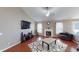 Bright living room features a fireplace, hardwood floors, and a large TV at 2228 Silver Rose Dr, Avon, IN 46123