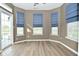 Light-filled sunroom featuring views of the lake with blue window blinds and a sliding glass door at 2228 Silver Rose Dr, Avon, IN 46123