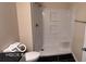 Bright bathroom featuring a toilet, a shower with seat and tiled floors at 229 Hillendale Dr, Greenwood, IN 46142