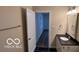 Bathroom with black tiled floor, and vanity with black countertop, a white cabinet and silver fixtures at 229 Hillendale Dr, Greenwood, IN 46142