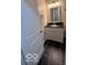 Modern bathroom featuring a vanity with a black countertop and a white cabinet on top of a black tiled floor at 229 Hillendale Dr, Greenwood, IN 46142