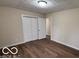Neutral bedroom featuring hardwood floors, white trim, closet and door with casing at 229 Hillendale Dr, Greenwood, IN 46142