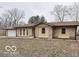 Charming ranch-style home featuring stone accents, attached two-car garage, and mature trees in the front yard at 229 Hillendale Dr, Greenwood, IN 46142