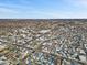 A sunny aerial view of a neighborhood with houses, streets, and sparse winter trees and snow at 234 N State Ave, Indianapolis, IN 46201