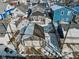 Aerial view of a gray house featuring a garage, back deck, and snowy fenced-in backyard at 234 N State Ave, Indianapolis, IN 46201
