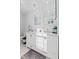 Bright bathroom featuring double sinks, white cabinets and countertops, and modern fixtures at 234 N State Ave, Indianapolis, IN 46201