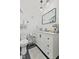 A modern bathroom featuring a black framed mirror and white vanity with storage at 234 N State Ave, Indianapolis, IN 46201