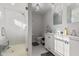 Bright bathroom featuring a glass-enclosed shower and double vanity with modern fixtures at 234 N State Ave, Indianapolis, IN 46201