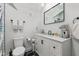 A modern bathroom featuring a black framed mirror and white vanity with storage at 234 N State Ave, Indianapolis, IN 46201