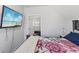 Bright bedroom features a TV and an open doorway leading to the hall at 234 N State Ave, Indianapolis, IN 46201