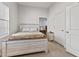 Comfortable bedroom with a full sized bed, neutral colors and a side table at 234 N State Ave, Indianapolis, IN 46201