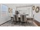 Elegant dining area featuring modern lighting and an open layout to the kitchen at 234 N State Ave, Indianapolis, IN 46201