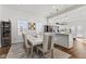 Bright dining room with a view into the kitchen, showcasing modern pendant lights at 234 N State Ave, Indianapolis, IN 46201