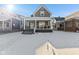 Charming home with a covered front porch and snow-covered front yard at 234 N State Ave, Indianapolis, IN 46201