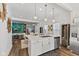 Spacious kitchen featuring stainless steel appliances and an island that overlooks the dining and living room area at 234 N State Ave, Indianapolis, IN 46201
