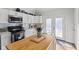 Well-appointed kitchen with a butcher block island, stainless steel appliances, and natural light at 234 N State Ave, Indianapolis, IN 46201