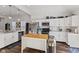 Bright kitchen features stainless steel appliances, modern cabinetry, a kitchen island with a butcher block top at 234 N State Ave, Indianapolis, IN 46201