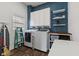 Well-organized laundry room with modern washer and dryer, cabinet storage, and a folding table at 234 N State Ave, Indianapolis, IN 46201