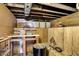 Unfinished basement with exposed ceiling and walls, and a table with items on top at 3329 W 10Th St, Indianapolis, IN 46222