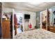 Inviting bedroom showcasing the door to the kitchen and floral wallpaper at 3329 W 10Th St, Indianapolis, IN 46222