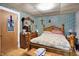 Comfortable bedroom with floral wallpaper, wood flooring, and a traditional-style bed frame at 3329 W 10Th St, Indianapolis, IN 46222