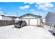 A two car garage with a vehicle in the driveway on a bright, snowy day at 3329 W 10Th St, Indianapolis, IN 46222
