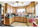 Well-maintained kitchen with wood cabinets, vintage countertops, and ample storage space at 3329 W 10Th St, Indianapolis, IN 46222