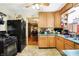 Functional kitchen with black appliances, wood cabinets, and an efficient layout at 3329 W 10Th St, Indianapolis, IN 46222
